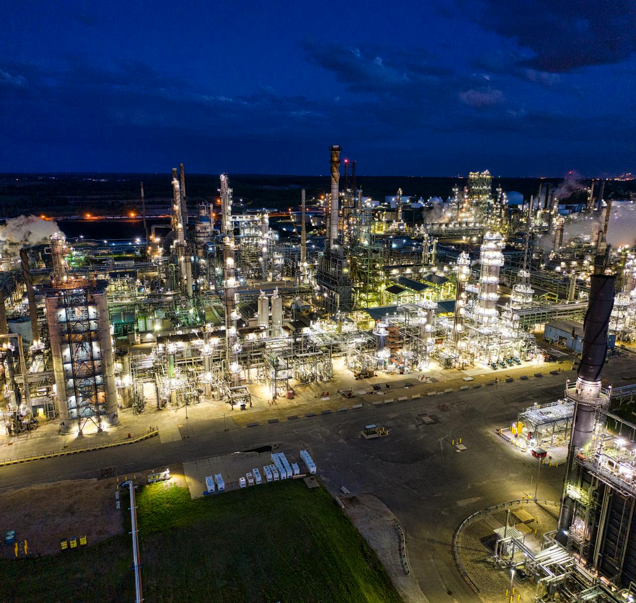 Dramatic aerial shot of an illuminated oil refinery at night in Rosemount, MN.